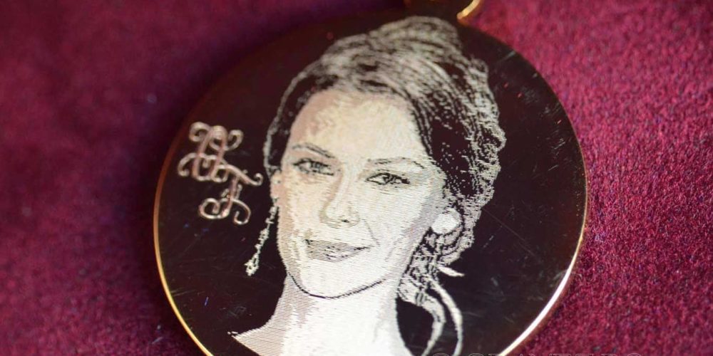 Photoengraving on a gold-plated pendant